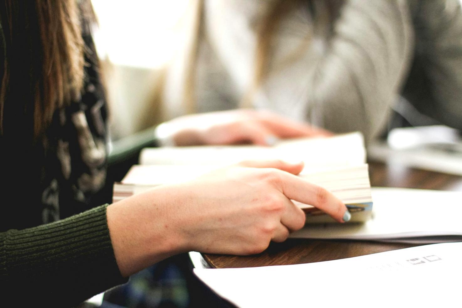 Team collaboration session with budget planning materials and whiteboards