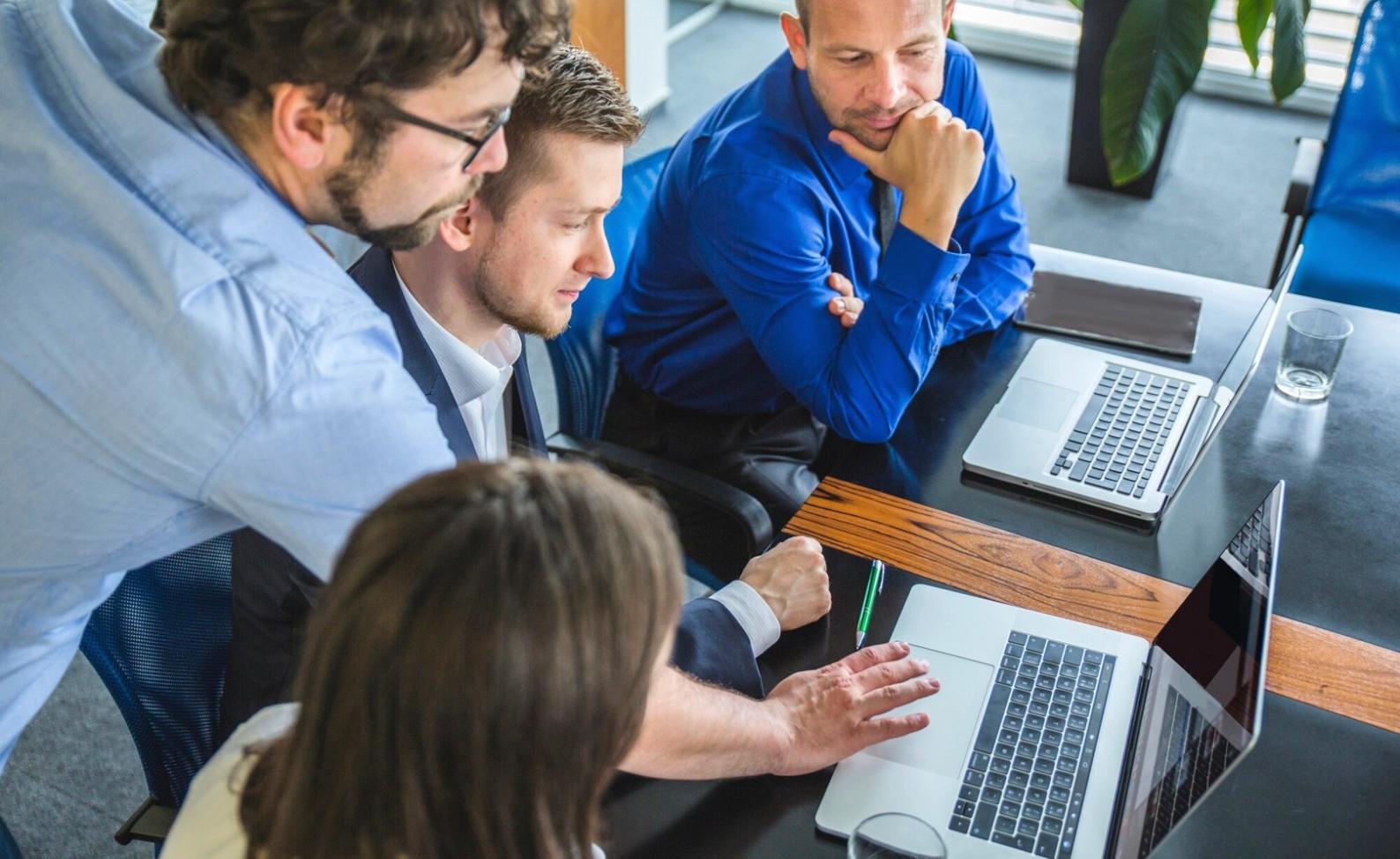 Professional team reviewing budget documents in modern office setting